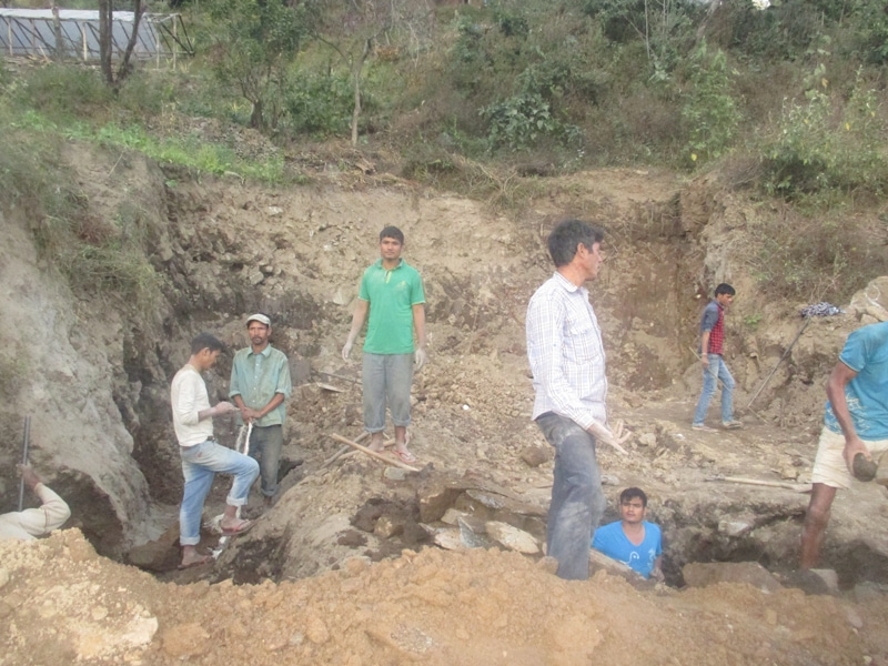Labourers are digging trenches for foundation to rebuild a house in Melamchi Municaplity.